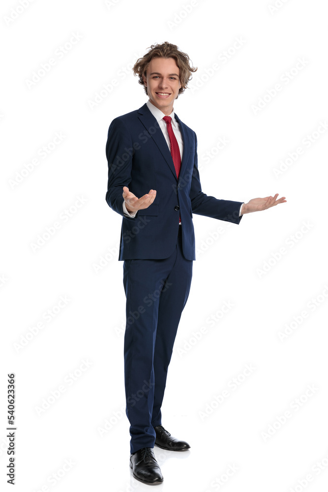 blond young man in elegant suit holding arms and gesturing blond young man in elegant suit holding arms and gesturing
