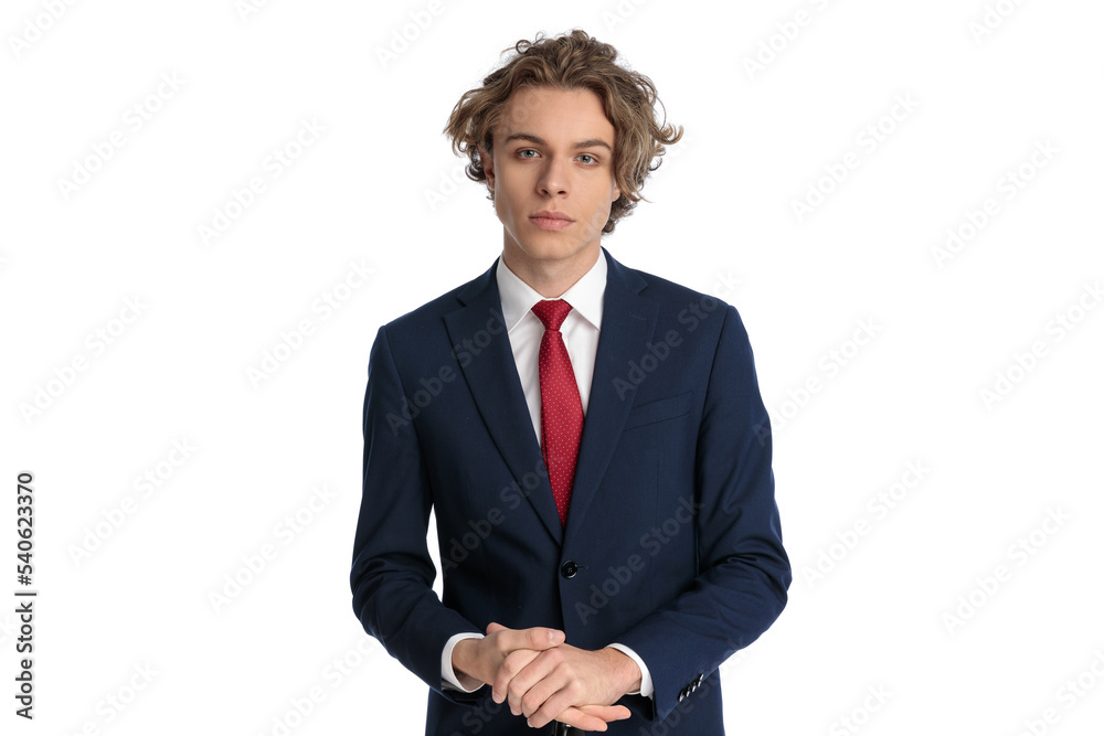 portrait of handsome man in elegant suit with red tie rubbing palms portrait of handsome man in elegant suit with red tie rubbing palms
