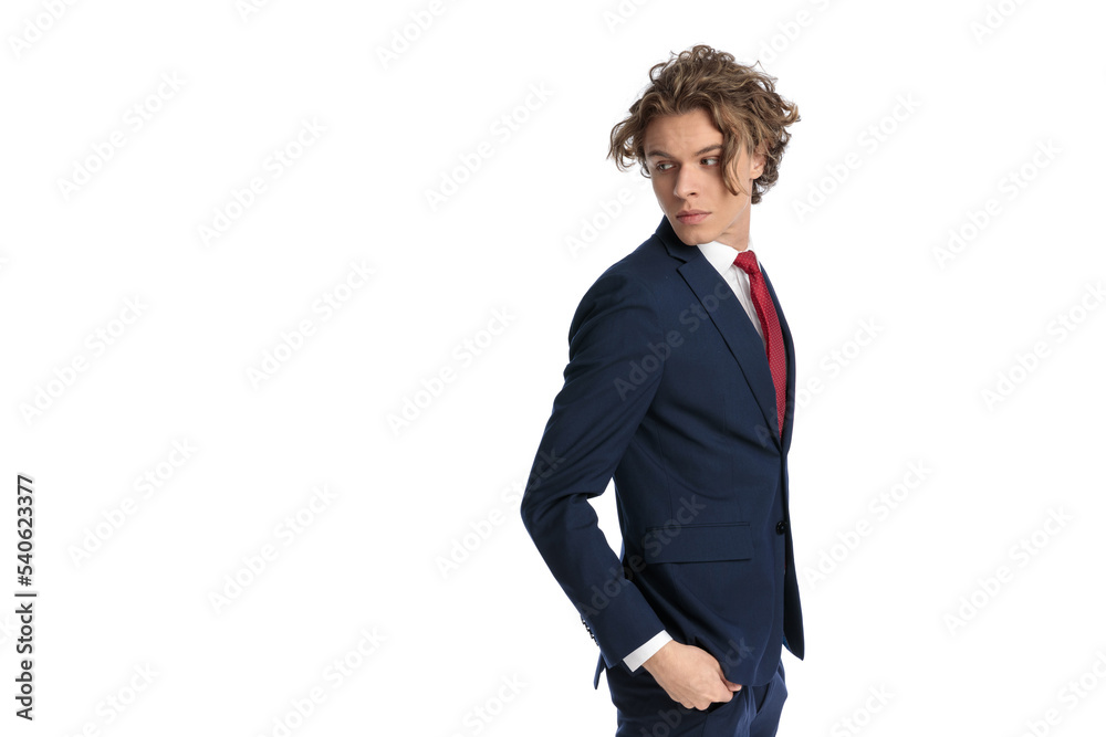 side view of sexy businessman with modern hairstyle looking over shoulder side view of sexy businessman with modern hairstyle looking over shoulder