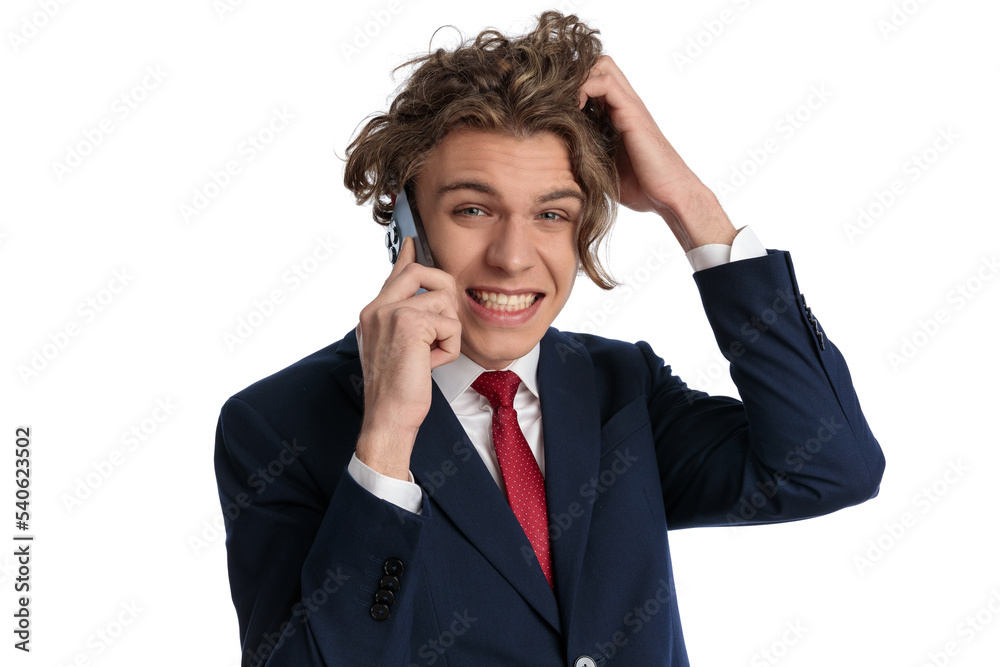 confused young businessman talking on the phone and scratching head confused young businessman talking on the phone and scratching head