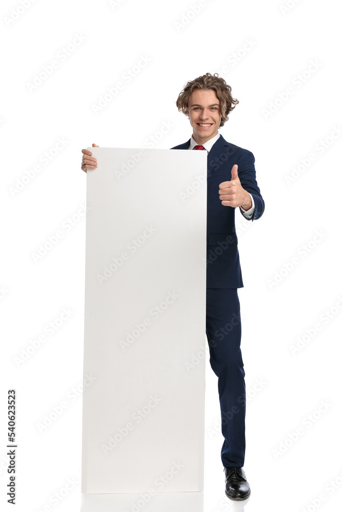 handsome businessman presenting white empty board and smiling handsome businessman presenting white empty board and smiling