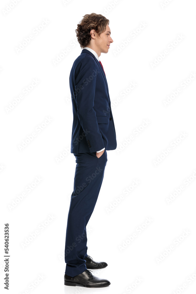 elegant businessman in suit holding hands in pockets and waiting in line elegant businessman in suit holding hands in pockets and waiting in line