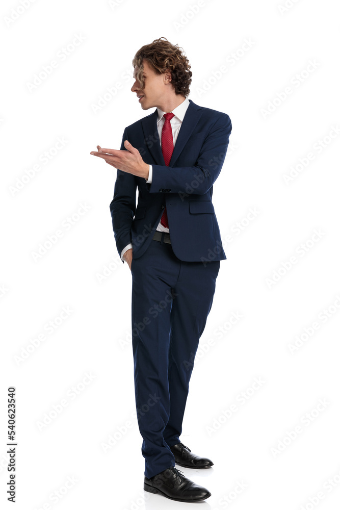 elegant businessman with long curly hair looking behind and talking elegant businessman with long curly hair looking behind and talking