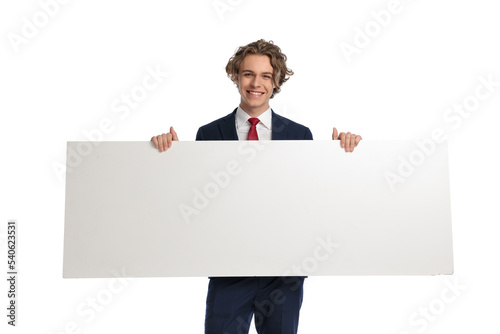 happy young businessman being excited while presenting advertisement board