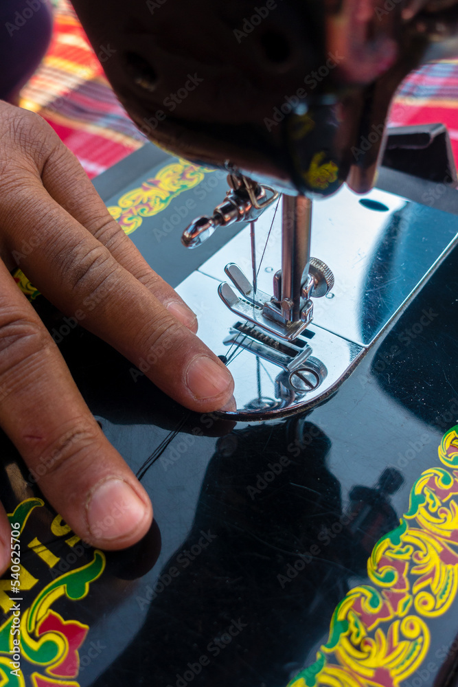 february 12th 2022, Dehradun City India. Hands operating manual Sewing