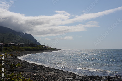 Picturesque seashore with rocks and beach on a sunny day with clear blue sky and calm ocean in Muroran, Hokkaido, northern Japan, Asia photo