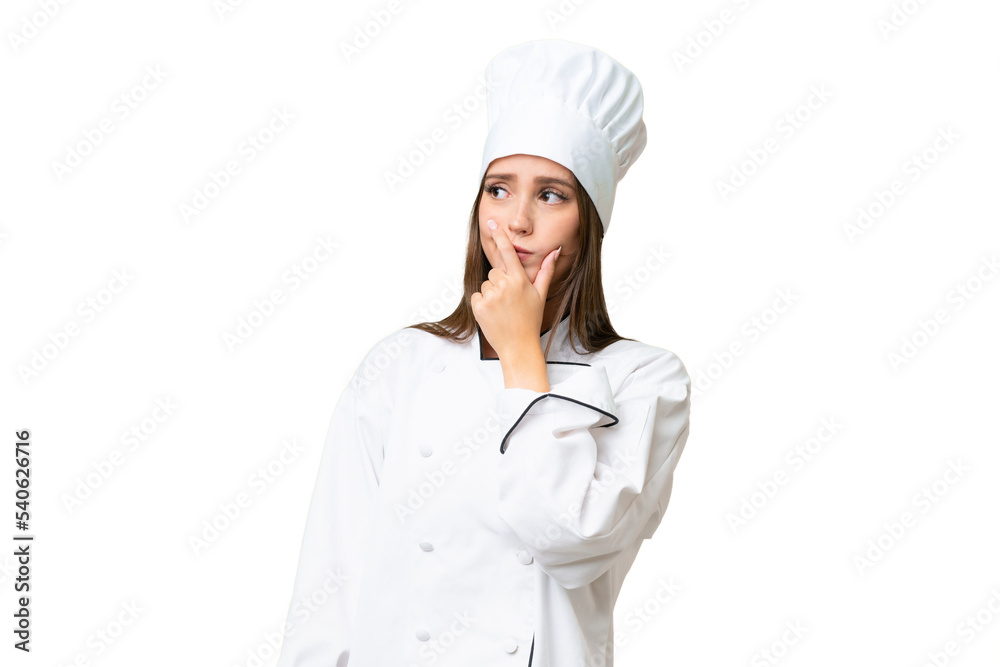 Young chef caucasian woman over isolated background having doubts and with confuse face expression