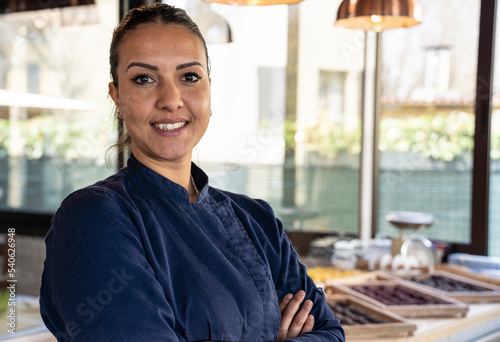 Young north african chef woman smiling on camera at the restaurant - Focus on face photo