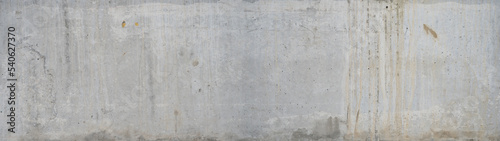 White gray exposed concrete wall - cement texture background banner panorama with efflorescence and rust spots weathered grunge pattern
