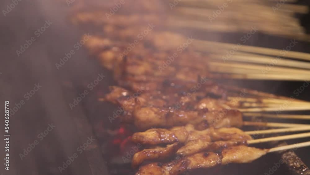 Slow motion video of Madura satay when it is burned