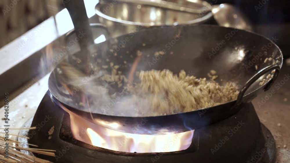 The process of making fried rice while the cook and stirred The process of making fried rice while the cook and stirred