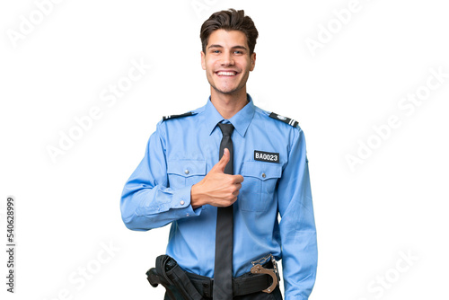 Young police man over isolated background giving a thumbs up gesture photo