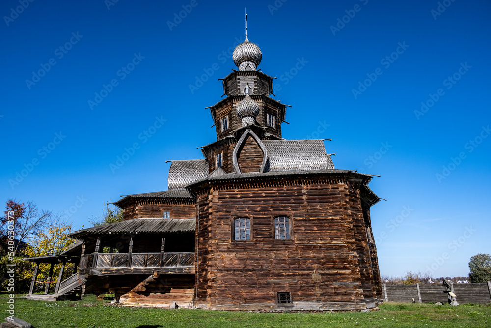 ancient wooden buildings as wonders of wooden architecture against the backdrop of autumn nature in Suzdal