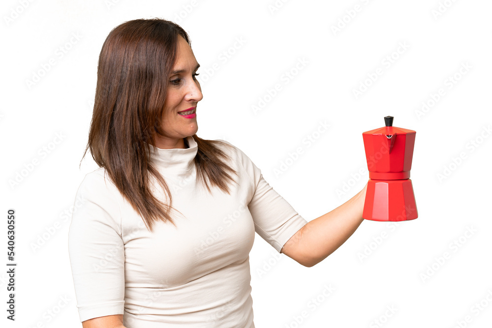 Middle-aged caucasian woman holding coffee pot over isolated background with happy expression Middle-aged caucasian woman holding coffee pot over isolated background with happy expression