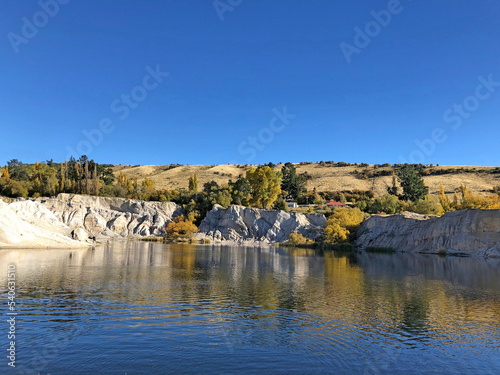 Spectacular lake and cliffs created by gold mine sluicings. in St Bathans and the Blue Lake, Maniototo District, New Zealand photo