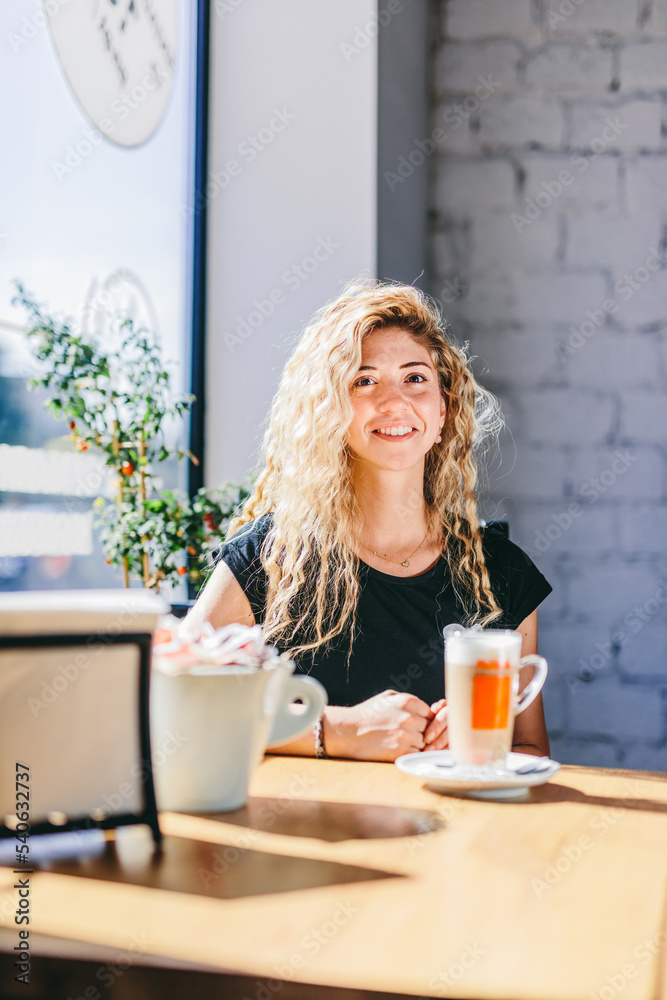 Woman having breakfast in restaurant with coffee and sandwich Woman having breakfast in restaurant with coffee and sandwich