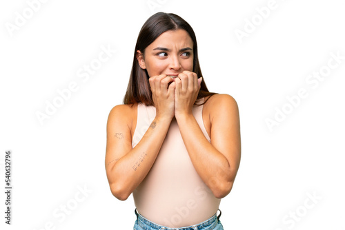 Young caucasian woman isolated on green chroma background nervous and scared putting hands to mouth