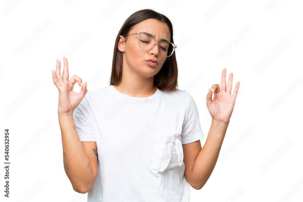 Young caucasian woman isolated on green chroma background in zen pose Young caucasian woman isolated on green chroma background in zen pose