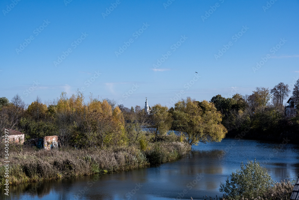 autumn landscape on a sunny day against the backdrop of ancient churches