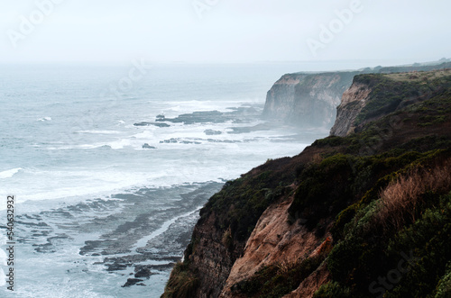 edge cliff of the northern coast of the pacific ocean in the early morning fog