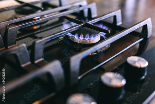 Gas flames burning on kitchen stove top