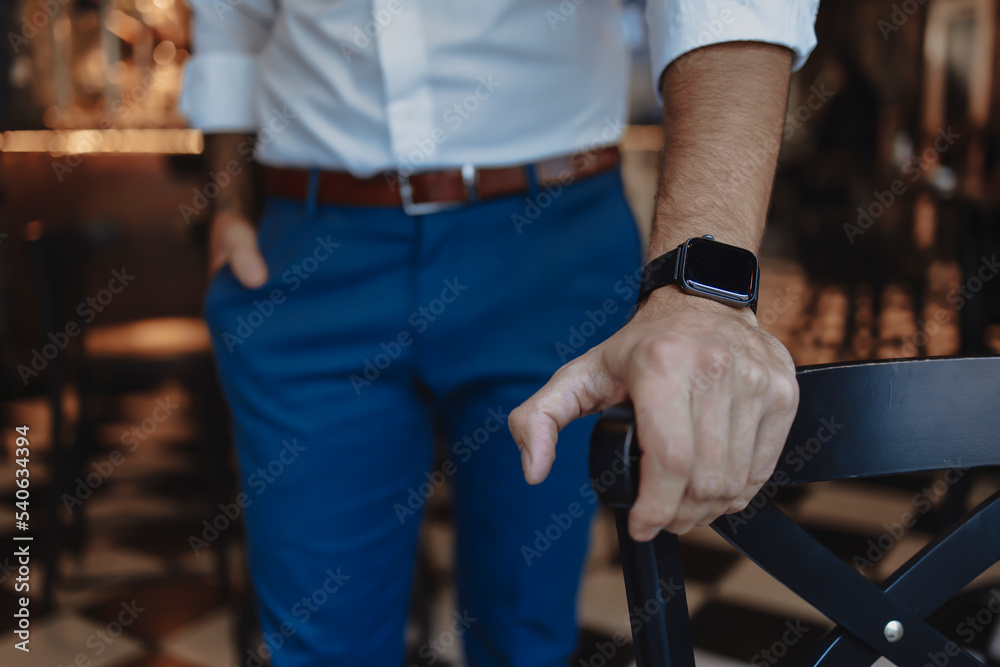 Hand of a young businessman wearing smart watch