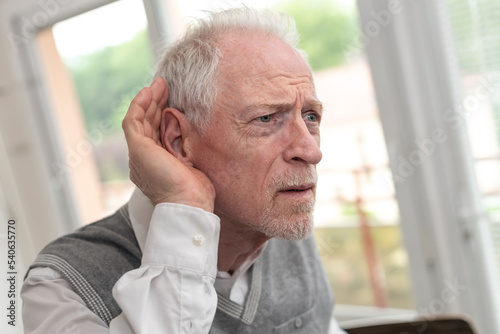 Senior man with hearing problems