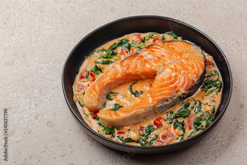 Close up of creamy garlic butter tuscan salmon. Pan seared salmon in a delicious creamy sauce with spinach and sun dried tomatoes.