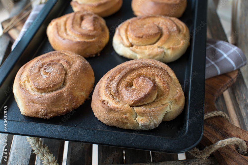 Homemade cinnamon rolls on a baking tray Homemade cinnamon rolls on a baking tray