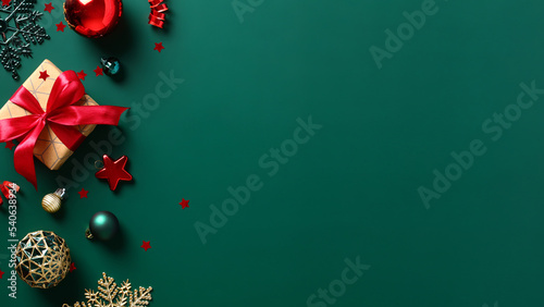 Dark green Christmas background with gift box, baubles, star, snowflakes. Happy New Year banner, Merry Christmas greeting card template.