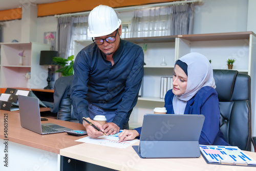 Intelligent office workers collaborating on new startup project using application for web design on modern laptop computers, male boss explain to woman details of next task on netbook indoors