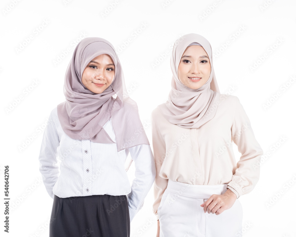 Portrait of two Muslim woman in office attire and wearing a hijab. Asian woman in a corporate world. Formal and elegant corporate outfit. Corporate or business people concept. Isolated