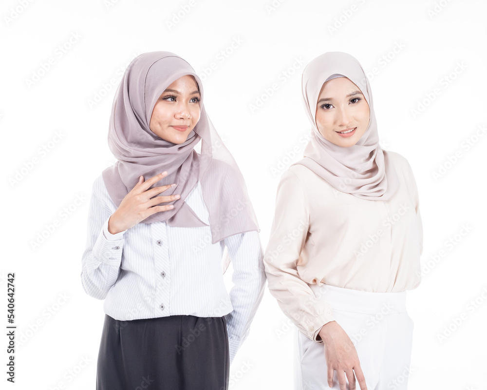 Portrait of two Muslim woman in office attire and wearing a hijab. Asian woman in a corporate world. Formal and elegant corporate outfit. Corporate or business people concept. Isolated