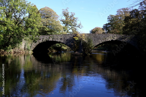 Old stone bridge carrying the A6 main road North over the River Kent in Cumbria, UK.