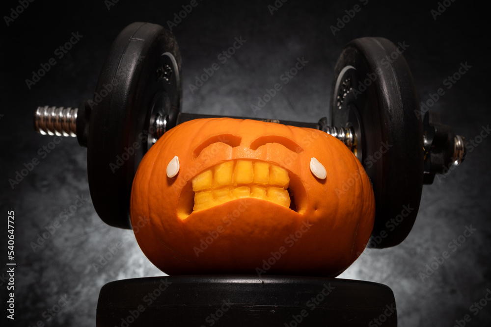 Carved Halloween Pumpkin Lifting A Heavy Barbell Dumbbell Carved Halloween Pumpkin Lifting A Heavy Barbell Dumbbell