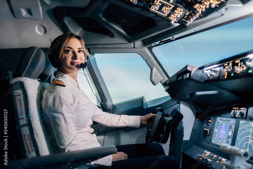 Woman pilot in the cockpit - obrazy, fototapety, plakaty 