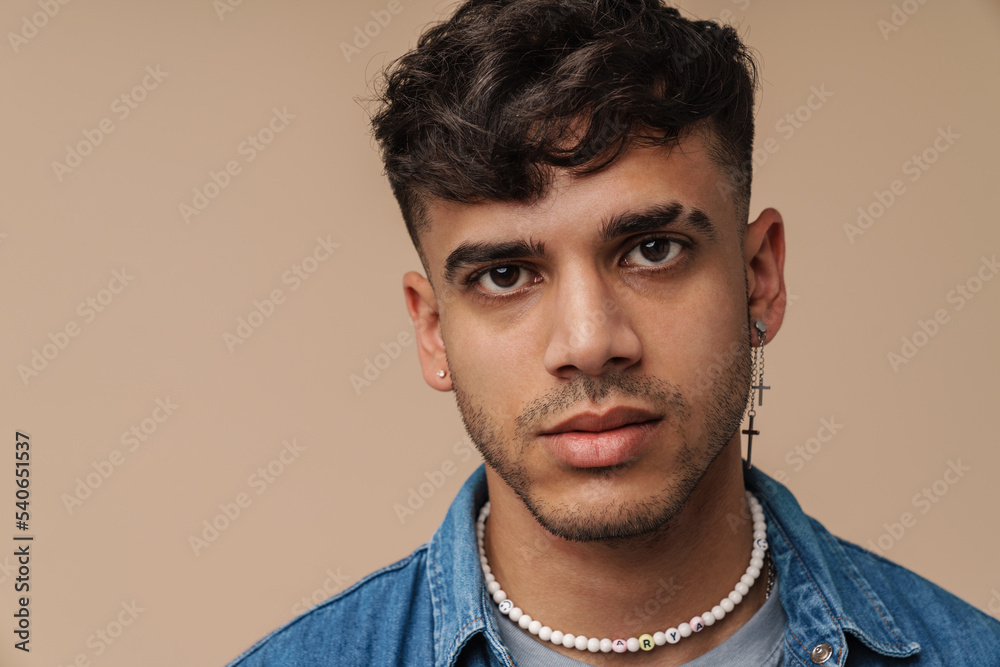 Obraz premium Young handsome stylish man with piercing looking at camera