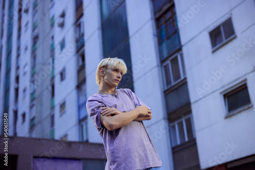 Portrait of a blonde teenage boy in the urban exterior.