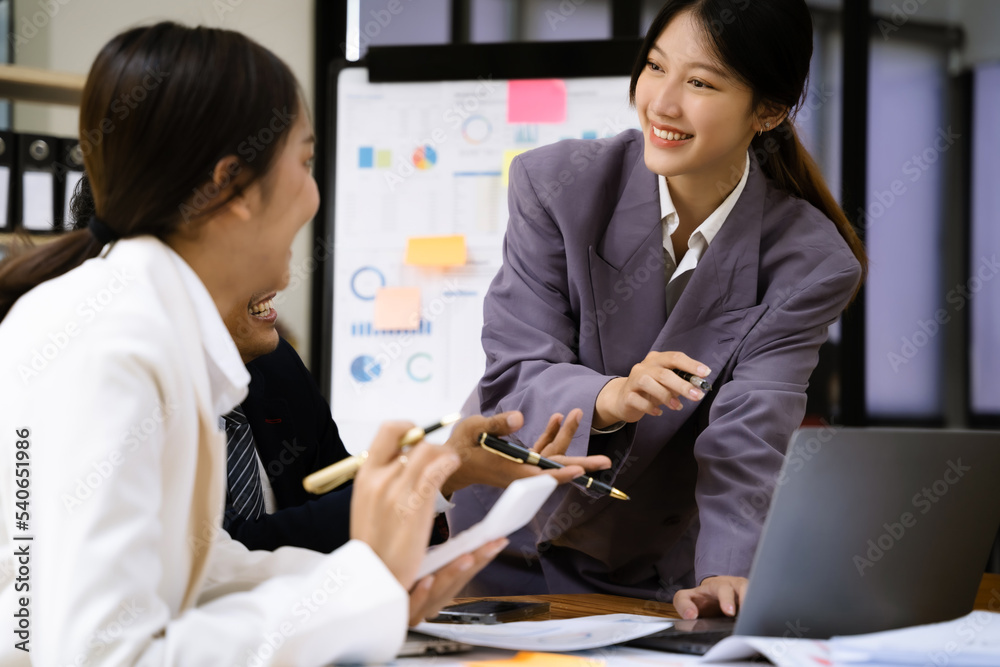 Group of Young Asian business team creative businesspeople coworker in office. Meeting Presentation for analysis graph company financial. Group of Young Asian business team creative businesspeople coworker in office. Meeting Presentation for analysis graph company financial.