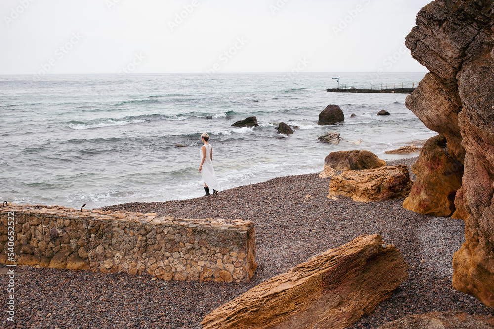 hipster woman wearing dress near sea in autumn