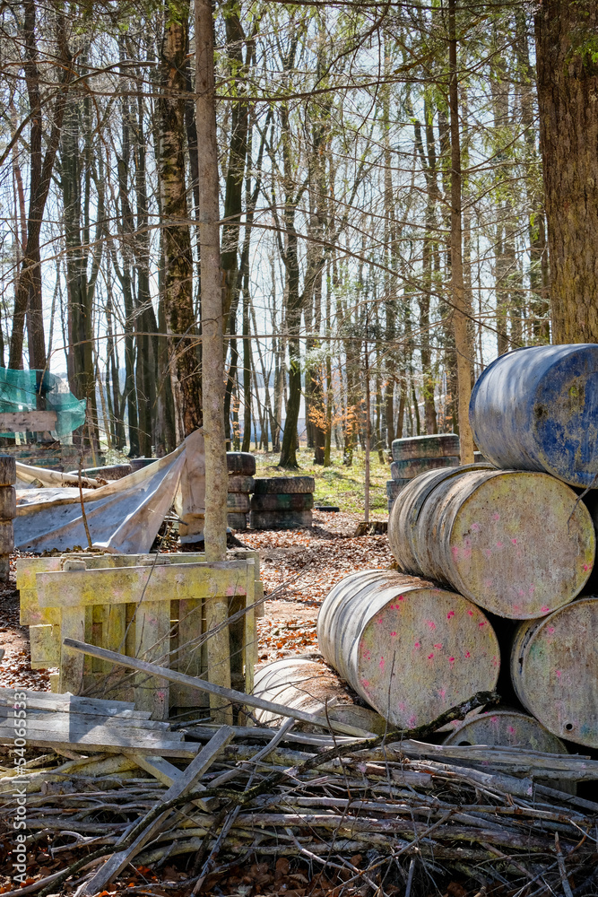 Metal barrels in the forest during the game, cover and shelter in