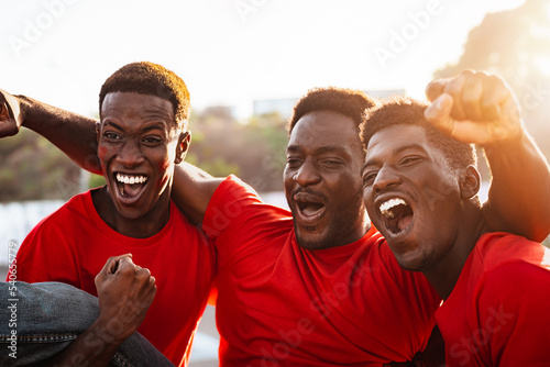 Obraz na płótnie African football fans having fun supporting their favorite team - Sport entertai