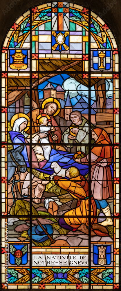 ANNEC, FRANCE - JULY 11, 2022: The  Nativity - Adoration of Shepherds in the stained glass of church Notre Dame de Lellis by L. Balmet (1933).