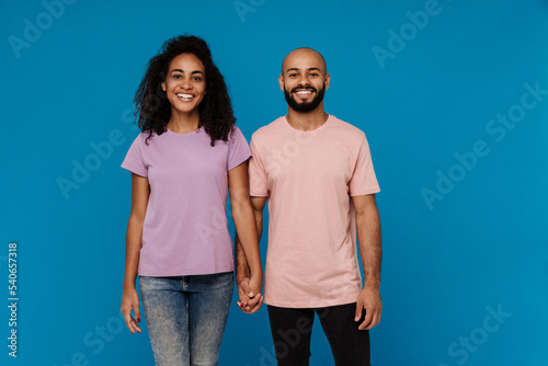 Black man and woman holding hands and smiling together