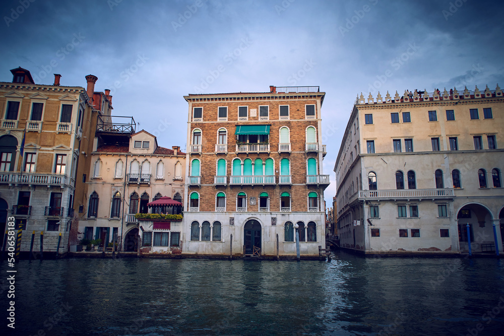 Traditional venetian houses and architecture style view across the Grand Canal in Venice, Italy. With Fondaco dei Tedeschi on the right
