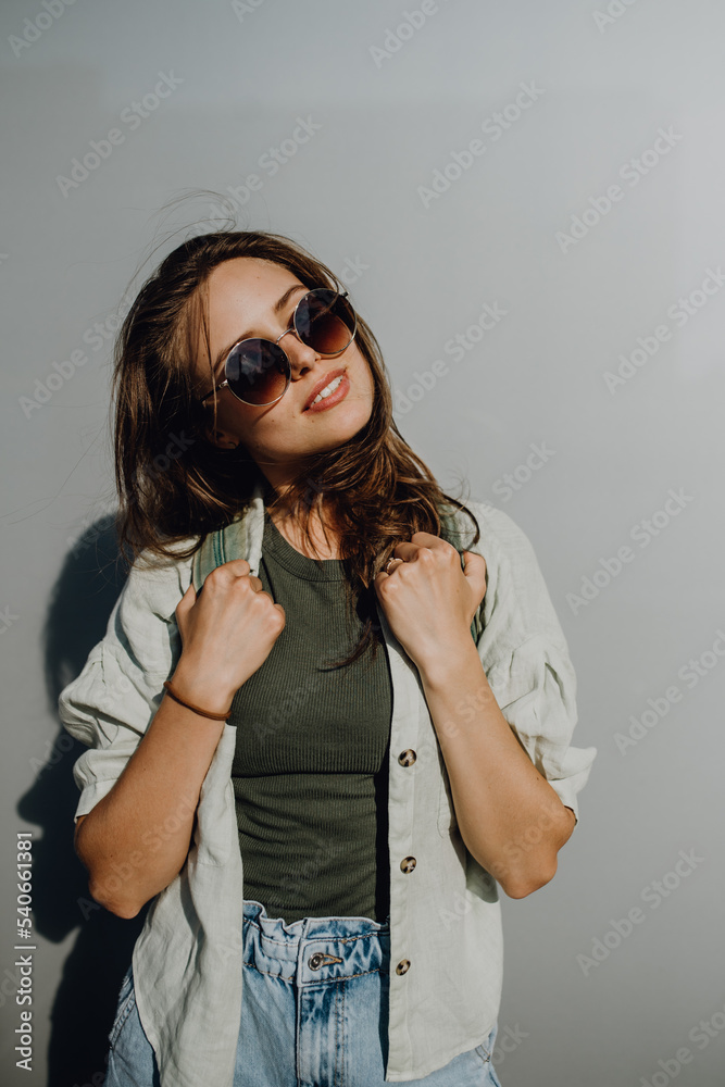 Portrait of happy young woman outdoor with backpack and sunglasses. Portrait of happy young woman outdoor with backpack and sunglasses.