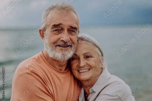 Portrait of senior couple in love, standing and hugging outdoor in nature.