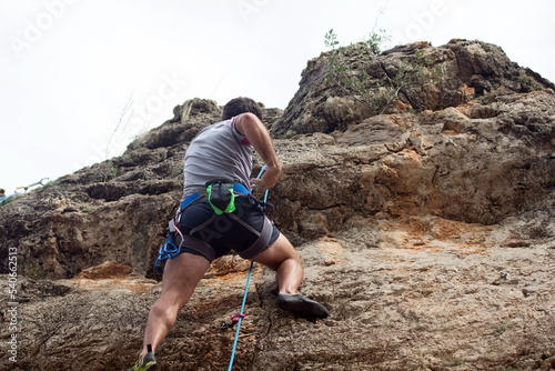 person climbing on the rocks
