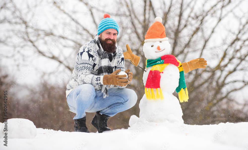 Snow games. Leisure on fresh air. Man bearded hipster cute knitted hat play with snow outdoors. Snowman concept. Have fun frosty winter day. Let it snow. Christmas holidays. Active lifestyle