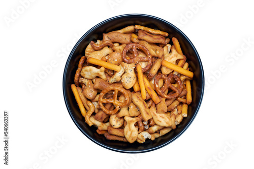 A snack bowl of salted savoury party food, crispy nibbles isolated against a transparent background viewed from above.
